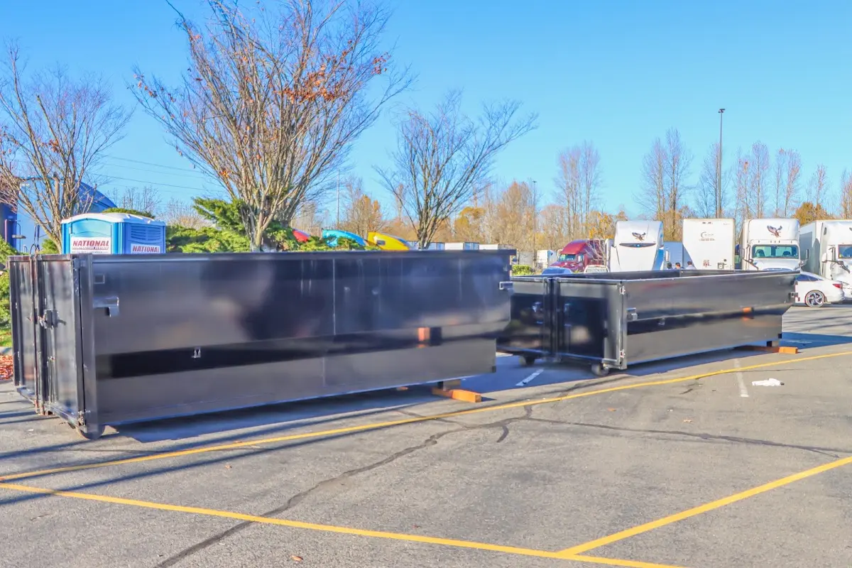 Professional dumpster rental service with roll-off container on residential driveway in Yorkshire